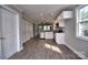 Modern kitchen featuring white cabinets, stainless steel appliances, and hardwood floors, creating a sleek design at 1479 Southwest Blvd, Newton, NC 28658