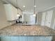 Kitchen island with granite countertops and white cabinets with stainless sink at 1479 Southwest Blvd, Newton, NC 28658