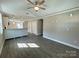 Open-concept living room features a ceiling fan and flows into kitchen at 1479 Southwest Blvd, Newton, NC 28658