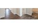 Hallway featuring wood-look floors leading to a bathroom and a carpeted bedroom at 159 Wembury Ln, Troutman, NC 28166