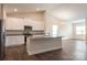 Open-concept kitchen and living room with lots of natural light, neutral paint, and modern appliances at 159 Wembury Ln, Troutman, NC 28166