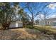 Backyard view showing shed and surrounding trees, offering privacy at 167 Saluda St, Chester, SC 29706