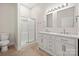 Bathroom featuring double sink vanity with marble countertops and shower with glass door at 167 Saluda St, Chester, SC 29706