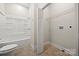 Bathroom features toilet and a shower over bath with storage shelves at 167 Saluda St, Chester, SC 29706