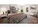 This bedroom features hardwood floors, light walls, two windows for natural light, and a luxurious bed and chair at 167 Saluda St, Chester, SC 29706