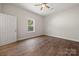 Bedroom features hardwood floors, a ceiling fan, and large windows at 167 Saluda St, Chester, SC 29706
