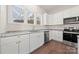 Modern kitchen featuring white cabinets, granite countertops, and stainless steel appliances at 167 Saluda St, Chester, SC 29706