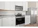 Kitchen close-up displaying stainless steel appliances and white cabinetry at 167 Saluda St, Chester, SC 29706