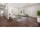 This living room has dark hardwood floors, light walls, a stylish sofa, and an ottoman for relaxing with company at 167 Saluda St, Chester, SC 29706