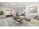 A bright living room with grey accent rug, hardwood floors, an open floor plan and large picture window with window seat at 167 Saluda St, Chester, SC 29706