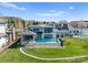 Aerial view of a modern home featuring a backyard swimming pool, well-manicured lawn, and beautiful landscaping at 18601 Bluff Point Rd, Cornelius, NC 28031