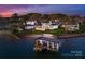 Luxury waterfront estate with private dock and beach access on a serene lake at sunset at 18601 Bluff Point Rd, Cornelius, NC 28031