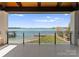 Breathtaking waterfront view from a spacious balcony with tile flooring, overlooking a serene lake landscape at 18601 Bluff Point Rd, Cornelius, NC 28031