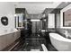 Elegant bathroom features luxurious finishes, a modern soaking tub, and a sleek glass enclosed shower at 18601 Bluff Point Rd, Cornelius, NC 28031