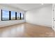 Bright bedroom features hardwood floors, large windows, and stunning lake views at 18601 Bluff Point Rd, Cornelius, NC 28031