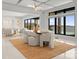 Open-concept dining area with modern lighting and picturesque lake views at 18601 Bluff Point Rd, Cornelius, NC 28031