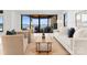 Bright living room boasts modern furnishings and expansive sliding glass doors with stunning water views at 18601 Bluff Point Rd, Cornelius, NC 28031