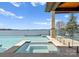 Inviting swimming pool and spa with clear blue water, set against a scenic waterfront backdrop at 18601 Bluff Point Rd, Cornelius, NC 28031