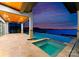 Inviting pool and spa with stunning waterfront views and a cozy lounge area at 18601 Bluff Point Rd, Cornelius, NC 28031