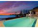 Beautiful pool and lake view at dusk at 18601 Bluff Point Rd, Cornelius, NC 28031