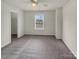 Bright bedroom with plush carpeting and a view of the backyard at 2006 Durand Rd, Fort Mill, SC 29715
