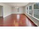 Spacious living room filled with natural light from many large windows and shiny hardwood floors at 2006 Durand Rd, Fort Mill, SC 29715