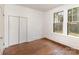 Bedroom featuring hardwood floors, closet, and windows for natural light at 211 W 6Th Ave, Gastonia, NC 28052