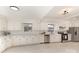 Bright kitchen featuring white cabinets, tiled backsplash, and stainless steel appliances at 211 W 6Th Ave, Gastonia, NC 28052