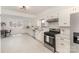 Spacious kitchen with stainless steel appliances, white cabinets and dining area at 211 W 6Th Ave, Gastonia, NC 28052