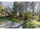 A serene backyard view highlighting the spacious patio area surrounded by mature trees and landscaping at 2129 Belle Chase Dr, Rock Hill, SC 29732
