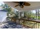 Relaxing covered porch with a ceiling fan, offering a serene view of the wooded backyard at 2129 Belle Chase Dr, Rock Hill, SC 29732