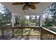 Cozy covered porch with wooden railing, providing a perfect spot to enjoy the peaceful backyard setting at 2129 Belle Chase Dr, Rock Hill, SC 29732