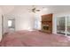 Open living room with fireplace and glass slider to patio at 2129 Belle Chase Dr, Rock Hill, SC 29732