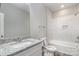 Bright bathroom featuring a granite vanity, a toilet and a shower with tiled walls at 213 Shannonhouse W St, Shelby, NC 28152