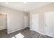 Bedroom featuring hardwood floors, neutral paint, and three doors at 213 Shannonhouse W St, Shelby, NC 28152