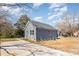 Side view of a light blue home with a paved driveway and a well-maintained lawn at 213 Shannonhouse W St, Shelby, NC 28152