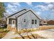 Quaint light blue house with porch, showcasing its cozy curb appeal and modern siding at 213 Shannonhouse W St, Shelby, NC 28152