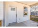 Cozy covered front porch with railings, front door, and window at 213 Shannonhouse W St, Shelby, NC 28152