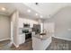 Island kitchen with gray counters, white cabinets and stainless steel appliances at 213 Shannonhouse W St, Shelby, NC 28152
