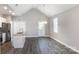 Open-concept living space with island, vaulted ceiling, and modern finishes at 213 Shannonhouse W St, Shelby, NC 28152
