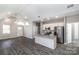 Open-concept living space with island, vaulted ceiling, and modern finishes at 213 Shannonhouse W St, Shelby, NC 28152