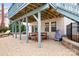 Covered backyard patio with picnic table and lounge chair, perfect for outdoor dining and relaxation at 215 Whitegrove Dr, Fort Mill, SC 29715