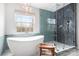 Bathroom featuring a modern free-standing tub, a large window, and a walk-in shower with glass doors at 215 Whitegrove Dr, Fort Mill, SC 29715