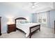 A bedroom with a tray ceiling, ceiling fan, large bed, bedside tables and lamps, and natural light from a window at 215 Whitegrove Dr, Fort Mill, SC 29715