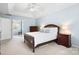 Bedroom featuring a wooden bed frame, bedside tables with lamps, and a view into the ensuite bathroom at 215 Whitegrove Dr, Fort Mill, SC 29715