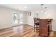 Light and airy dining area with bar, wooden chairs, and doors to the pool at 215 Whitegrove Dr, Fort Mill, SC 29715