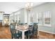 Dining room featuring a chandelier, wooden floors, and natural light from large windows at 215 Whitegrove Dr, Fort Mill, SC 29715