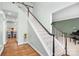 A naturally lit foyer with hardwood floors, stairs, and views into other rooms at 215 Whitegrove Dr, Fort Mill, SC 29715