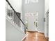 Bright foyer with hardwood floors, a staircase with black accents, and a clear front door at 215 Whitegrove Dr, Fort Mill, SC 29715