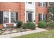 Close-up of a brick home's entrance with an inviting porch and neatly landscaped bushes at 215 Whitegrove Dr, Fort Mill, SC 29715